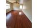 Bright bedroom with hardwood flooring, fan, and natural light from two windows at 8149 Palace Monaco Ave, Las Vegas, NV 89117