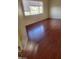 Bedroom featuring laminate floors, a window with blinds, and ample natural light at 8149 Palace Monaco Ave, Las Vegas, NV 89117