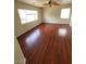 Bright bedroom with hardwood flooring, fan, and natural light from two windows at 8149 Palace Monaco Ave, Las Vegas, NV 89117