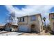 Beautiful two-story home with neutral stucco exterior, an attached garage, and an arched front entry at 8149 Palace Monaco Ave, Las Vegas, NV 89117