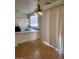 Bright kitchen area with a breakfast bar, wood floors, white cabinets, and hanging decorative light fixture at 8149 Palace Monaco Ave, Las Vegas, NV 89117