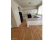 Bright kitchen featuring white cabinets, wood flooring, black appliances, and an extended breakfast bar at 8149 Palace Monaco Ave, Las Vegas, NV 89117