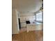 Kitchen area features white cabinets, wood floor, breakfast bar, and black appliances at 8149 Palace Monaco Ave, Las Vegas, NV 89117