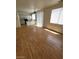 Open-concept living space with hardwood floors and natural light connecting to a modern kitchen at 8149 Palace Monaco Ave, Las Vegas, NV 89117