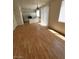 Open living area with wood floors, kitchen, and natural light from sliding glass doors and windows at 8149 Palace Monaco Ave, Las Vegas, NV 89117