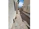 Image of the home's side yard with gravel ground cover and partial fencing at 8149 Palace Monaco Ave, Las Vegas, NV 89117