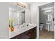 Well-lit bathroom featuring a double sink vanity with a large mirror and a separate toilet area at 8255 Las Vegas Blvd # 1219, Las Vegas, NV 89123