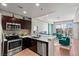 Modern kitchen and living room area with stainless steel appliances, light countertops, and views at 8255 Las Vegas Blvd # 1219, Las Vegas, NV 89123