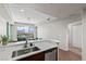 Modern kitchen featuring stainless steel appliances, countertops, and a view of the living space at 8255 Las Vegas Blvd # 1219, Las Vegas, NV 89123
