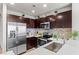 Kitchen featuring stainless steel appliances, light countertops, and ample dark wood cabinetry at 8255 Las Vegas Blvd # 1219, Las Vegas, NV 89123