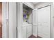 Convenient laundry closet equipped with a stacked washer and dryer unit and storage shelves at 8255 Las Vegas Blvd # 1219, Las Vegas, NV 89123