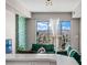 Stylish living room featuring comfortable green velvet sofas and an amazing city view at 8255 Las Vegas Blvd # 1219, Las Vegas, NV 89123