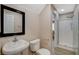 Compact bathroom featuring a pedestal sink and a glass-enclosed shower at 8307 Fort Hallock Ave, Las Vegas, NV 89131