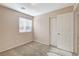 Bright bedroom features carpeted floors, a window, and a closet for storage at 8307 Fort Hallock Ave, Las Vegas, NV 89131