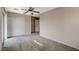 Bedroom features neutral-colored walls, plush carpeting, a closet, and an entry doorway to a hallway at 8307 Fort Hallock Ave, Las Vegas, NV 89131
