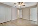 Bedroom with a ceiling fan features wood-look floors, closet, and an ensuite bathroom at 8307 Fort Hallock Ave, Las Vegas, NV 89131