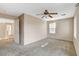 Bedroom features neutral-colored walls, plush carpeting, natural light, and doorway to a hallway at 8307 Fort Hallock Ave, Las Vegas, NV 89131