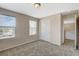 Bedroom featuring neutral-colored walls, plush carpeting, a closet, and natural light from multiple windows at 8307 Fort Hallock Ave, Las Vegas, NV 89131