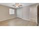 Light-filled bedroom features wood-look floors, closet with double doors, and an ensuite bathroom at 8307 Fort Hallock Ave, Las Vegas, NV 89131