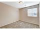 Neutral bedroom featuring carpeted floors and a window with blinds for natural light at 8307 Fort Hallock Ave, Las Vegas, NV 89131