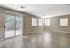 Bonus room featuring sliding door access to the backyard and multiple windows at 8307 Fort Hallock Ave, Las Vegas, NV 89131