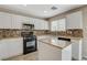 Kitchen with an island, sleek countertops, modern appliances, and ample cabinet space at 8307 Fort Hallock Ave, Las Vegas, NV 89131