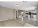 Open concept living space with wood-look floors, modern kitchen, and staircase to the second floor at 8307 Fort Hallock Ave, Las Vegas, NV 89131