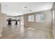 Spacious living area with wood-look floors, a modern kitchen, and a sliding door to the backyard at 8307 Fort Hallock Ave, Las Vegas, NV 89131