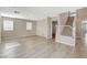 Open living room with light wood flooring and staircase to second level at 8307 Fort Hallock Ave, Las Vegas, NV 89131