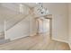 Bright living room featuring a staircase and modern lighting fixtures at 8307 Fort Hallock Ave, Las Vegas, NV 89131