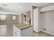 Open kitchen with an island, stainless-steel appliances, and an attached living area at 8307 Fort Hallock Ave, Las Vegas, NV 89131