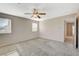 Large main bedroom featuring carpeted floors, a ceiling fan, and natural light from windows at 8307 Fort Hallock Ave, Las Vegas, NV 89131