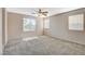 Spacious main bedroom with carpeted floors, a ceiling fan, and lots of natural light at 8307 Fort Hallock Ave, Las Vegas, NV 89131