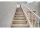 Staircase features wood-look steps and white railings, with a view of the upper level at 8307 Fort Hallock Ave, Las Vegas, NV 89131