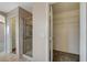 Walk-in closet with wire shelving, carpet, and access to an en-suite bathroom with a walk-in shower at 8307 Fort Hallock Ave, Las Vegas, NV 89131