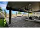 Relax in the outdoor living space with a covered patio, ceiling fans, and stylish stone flooring at 8316 Maplestar Rd, Las Vegas, NV 89128