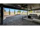 The spacious patio features a covered area, a fan, and stone flooring for seamless indoor-outdoor living at 8316 Maplestar Rd, Las Vegas, NV 89128