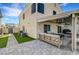 Wonderful backyard with paved patio, seating area, and artificial grass at 8316 Maplestar Rd, Las Vegas, NV 89128