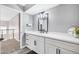 Modern bathroom features a double sink vanity, dark hardware, and quartz countertops at 8316 Maplestar Rd, Las Vegas, NV 89128