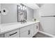Modern bathroom features a double sink vanity, dark hardware, and quartz countertops at 8316 Maplestar Rd, Las Vegas, NV 89128
