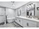 Modern bathroom featuring double sinks, a soaking tub, and a glass-enclosed shower with black hardware accents at 8316 Maplestar Rd, Las Vegas, NV 89128