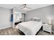 Cozy bedroom boasts a mirrored closet with shelves, ceiling fan, and light gray walls at 8316 Maplestar Rd, Las Vegas, NV 89128