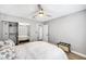 This bedroom features wood look floors, a mirrored closet with shelves and a ceiling fan at 8316 Maplestar Rd, Las Vegas, NV 89128