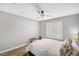This bedroom features wood look floors, shuttered windows and a ceiling fan at 8316 Maplestar Rd, Las Vegas, NV 89128