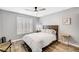 This bedroom features wood look floors, shuttered windows and a ceiling fan at 8316 Maplestar Rd, Las Vegas, NV 89128