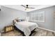 Bright bedroom features a ceiling fan, shuttered windows, wood-look floors, and neutral color scheme at 8316 Maplestar Rd, Las Vegas, NV 89128
