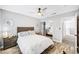 This bedroom features wood look floors, a mirrored closet and a ceiling fan at 8316 Maplestar Rd, Las Vegas, NV 89128