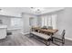 Dining area featuring a modern table with seating for six and bright, shuttered windows at 8316 Maplestar Rd, Las Vegas, NV 89128
