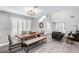 A spacious dining room features a large wooden table, ample seating, and stylish decor at 8316 Maplestar Rd, Las Vegas, NV 89128