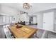 Open-concept dining area with wood table, decorative centerpiece, and modern lighting at 8316 Maplestar Rd, Las Vegas, NV 89128